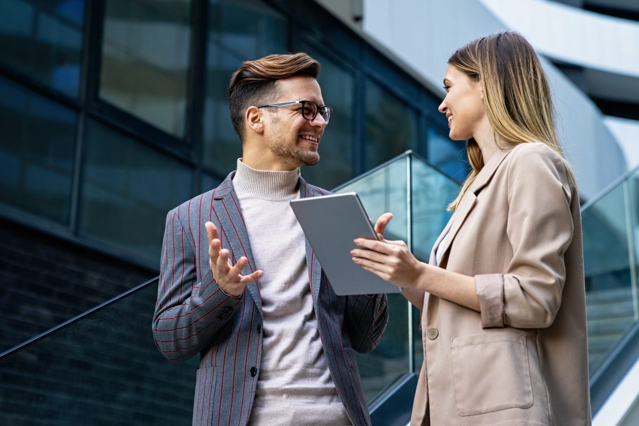 Two creative business people working on social media strategy using a digital tablet.jpg